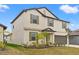 Two-story house with a large garage and manicured lawn at 194 Argyll Dr, Spring Hill, FL 34609
