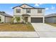 Two-story house with a two-car garage and landscaping at 194 Argyll Dr, Spring Hill, FL 34609