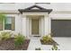 House entrance with green door and landscaping at 194 Argyll Dr, Spring Hill, FL 34609