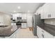 Modern kitchen with white cabinets and granite countertops at 194 Argyll Dr, Spring Hill, FL 34609