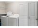 Convenient laundry room with washer, dryer, and cabinets at 194 Argyll Dr, Spring Hill, FL 34609