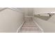 Carpeted staircase with neutral-toned walls at 194 Argyll Dr, Spring Hill, FL 34609