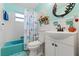 Bathroom with a teal tub and nautical-themed decor at 2015 Park N St, St Petersburg, FL 33710