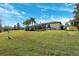 Large backyard with lush grass and trees at 20200 Lace Cascade Rd, Land O Lakes, FL 34637