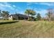 House with screened-in patio and sloped lawn at 20200 Lace Cascade Rd, Land O Lakes, FL 34637