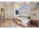 Elegant bathroom with soaking tub, tile flooring, and large window at 20200 Lace Cascade Rd, Land O Lakes, FL 34637