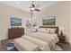 Bedroom with plush bed, bench, and ceiling fan at 20200 Lace Cascade Rd, Land O Lakes, FL 34637