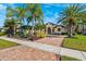 Beautiful house with palm trees and a large driveway at 20200 Lace Cascade Rd, Land O Lakes, FL 34637