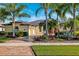 House with palm trees and a brick driveway at 20200 Lace Cascade Rd, Land O Lakes, FL 34637