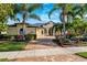 House with palm trees and a brick driveway at 20200 Lace Cascade Rd, Land O Lakes, FL 34637