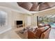 Gathering room with a cozy atmosphere, leather furniture, and access to a patio at 20200 Lace Cascade Rd, Land O Lakes, FL 34637