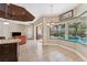 Relaxing Gathering room with leather armchairs, a ceiling fan, and access to the pool area at 20200 Lace Cascade Rd, Land O Lakes, FL 34637