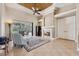 Gathering room with fireplace and view of the pool and lanai at 20200 Lace Cascade Rd, Land O Lakes, FL 34637