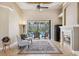 Gathering room features a fireplace and sliding doors to the pool area at 20200 Lace Cascade Rd, Land O Lakes, FL 34637