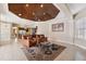 Comfortable Gathering room featuring a coffered ceiling, leather furniture, and a large TV at 20200 Lace Cascade Rd, Land O Lakes, FL 34637