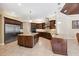 Spacious kitchen featuring a large island, stainless steel appliances, and dark wood cabinets at 20200 Lace Cascade Rd, Land O Lakes, FL 34637