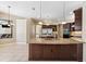 Open kitchen with large island, granite countertops, and stainless steel appliances at 20200 Lace Cascade Rd, Land O Lakes, FL 34637