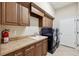 Laundry room with washer, dryer, and cabinets at 20200 Lace Cascade Rd, Land O Lakes, FL 34637