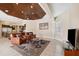 Spacious living room with leather armchairs and a view into the kitchen at 20200 Lace Cascade Rd, Land O Lakes, FL 34637