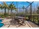Outdoor dining area with a view of the pool and nature at 20200 Lace Cascade Rd, Land O Lakes, FL 34637