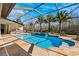 Inviting screened pool and spa with outdoor kitchen at 20200 Lace Cascade Rd, Land O Lakes, FL 34637