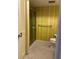 Bathroom featuring sink with cabinets, commode, and glass door shower with yellow accents at 2718 Highlands Blvd # A, Palm Harbor, FL 34684