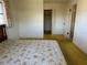 Neutral bedroom with white walls, yellow carpet, and view of closet and doorway at 2718 Highlands Blvd # A, Palm Harbor, FL 34684