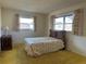 Cozy bedroom with carpet, neutral walls, and two windows with curtains allowing natural light at 2718 Highlands Blvd # A, Palm Harbor, FL 34684