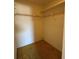 Small closet with wire rack for hanging clothes and yellow carpet at 2718 Highlands Blvd # A, Palm Harbor, FL 34684