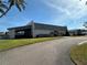 Community clubhouse showcasing well-maintained landscaping, a covered outdoor space, and a serene atmosphere at 2718 Highlands Blvd # A, Palm Harbor, FL 34684