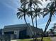 Exterior of a community building surrounded by well-maintained landscaping and palm trees at 2718 Highlands Blvd # A, Palm Harbor, FL 34684