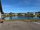 Scenic view of a community pond with a fountain, surrounded by well-kept lawns and charming homes at 2718 Highlands Blvd # A, Palm Harbor, FL 34684
