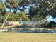 Highland Lakes active adult golf community sign with a water fountain, and beautiful landscaping at 2718 Highlands Blvd # A, Palm Harbor, FL 34684