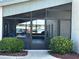 View of an outdoor seating area with a screen enclosure surrounded by lush landscaping at 2718 Highlands Blvd # A, Palm Harbor, FL 34684