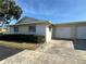 Exterior angle showing the attached two-car garage and well maintained lawn and landscaping at 2718 Highlands Blvd # A, Palm Harbor, FL 34684