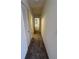 Long hallway with carpeting and access to various rooms in the house at 2718 Highlands Blvd # A, Palm Harbor, FL 34684