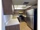 The kitchen has wood cabinets, white countertops, stainless steel appliances, and tile floor at 2718 Highlands Blvd # A, Palm Harbor, FL 34684