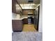 A functional kitchen with stainless steel appliances, wood cabinets, and yellow laminate countertops at 2718 Highlands Blvd # A, Palm Harbor, FL 34684