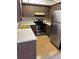 Compact kitchen with stainless steel appliances, wood cabinets, and laminate countertops at 2718 Highlands Blvd # A, Palm Harbor, FL 34684