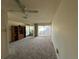 Bright living room with a ceiling fan, carpet, and sliding glass doors to a patio at 2718 Highlands Blvd # A, Palm Harbor, FL 34684