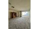 The spacious living room has carpet, a ceiling fan, and sliding glass doors leading to outdoor patio at 2718 Highlands Blvd # A, Palm Harbor, FL 34684
