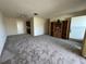 Living room featuring neutral carpet and access to other rooms, creating an open flow throughout the home at 2718 Highlands Blvd # A, Palm Harbor, FL 34684