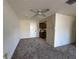 Cozy living room with neutral carpet, ceiling fan, and doorway to the kitchen for easy access at 2718 Highlands Blvd # A, Palm Harbor, FL 34684