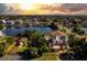 Sunset aerial view of waterfront home with detached workshop and lush landscaping at 3308 Oleander Dr, Hernando Beach, FL 34607