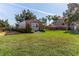 Landscaped backyard with a large storage shed and lush greenery at 3308 Oleander Dr, Hernando Beach, FL 34607