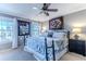 King-size bed in bright bedroom with ceiling fan and large windows at 3308 Oleander Dr, Hernando Beach, FL 34607