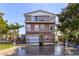 Two-story home with gated entry and balcony at 3308 Oleander Dr, Hernando Beach, FL 34607