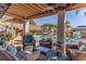 Inviting covered patio with comfortable seating overlooks a sparkling pool and picturesque waterfront view at 3308 Oleander Dr, Hernando Beach, FL 34607