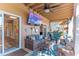 Covered patio with wicker furniture and large TV at 3308 Oleander Dr, Hernando Beach, FL 34607