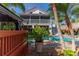 Inviting pool area with a two-story home and lush tropical landscaping at 3308 Oleander Dr, Hernando Beach, FL 34607
